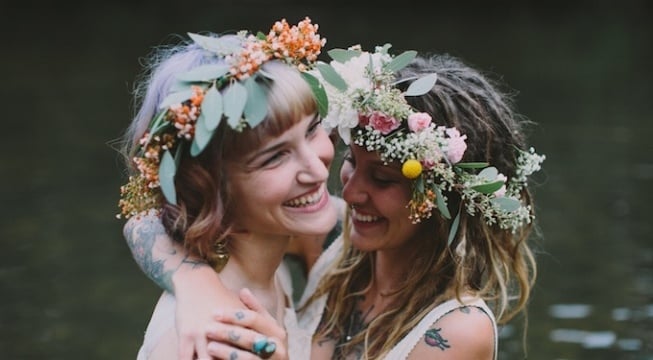 two women with flower headdresses embracing