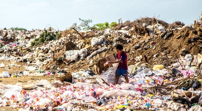 boy standing on trash