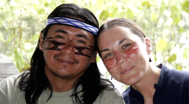 Achuar man with black face paint and woman with red face pain