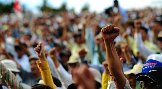 people with fists raised at protest 