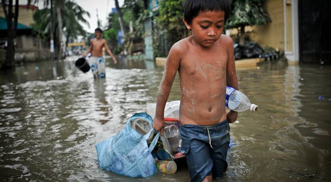 child wading in flood